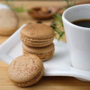 Hazelnut flavored coffee in a cup next to hazelnut cookies