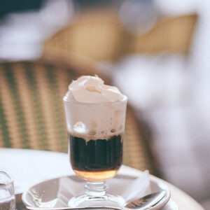 Irish Cream flavored coffee in a glass mug with whipped cream on top