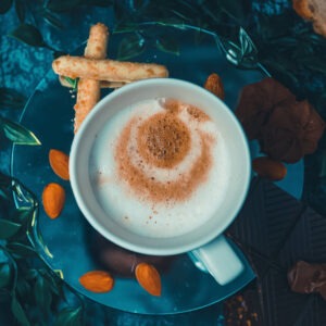 Vanilla almond flavored coffee in a cup on a saucer with two almond cookies