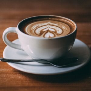 Jamaican Me nuts flavored coffee in a cup with a foam design on top